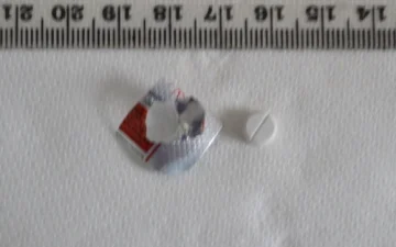 White round tramadol tablet beside its blister packaging